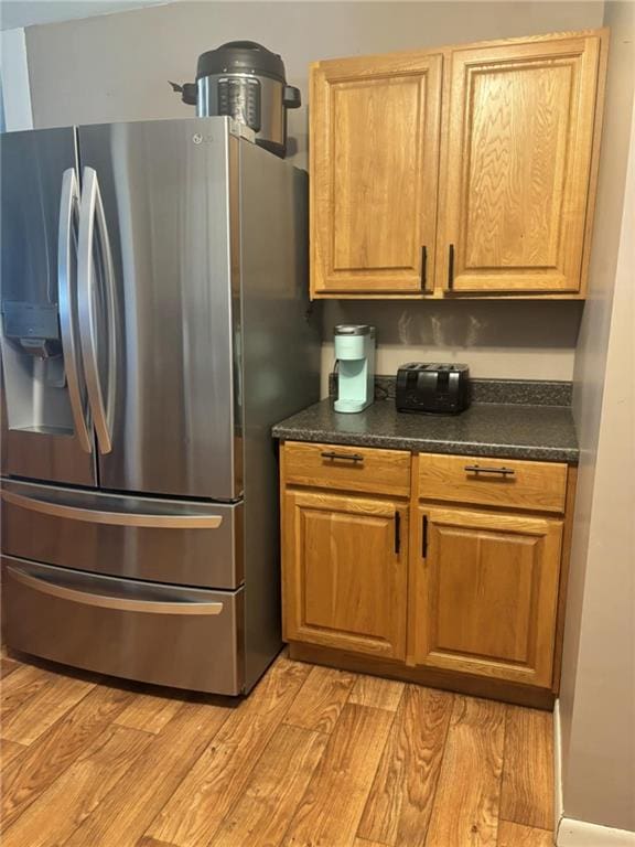 32592 SE 500th Rd, Kincaid, KS 66039 - kitchen with stainless steel refrigerator with ice dispenser, dark countertops, and light wood finished floors