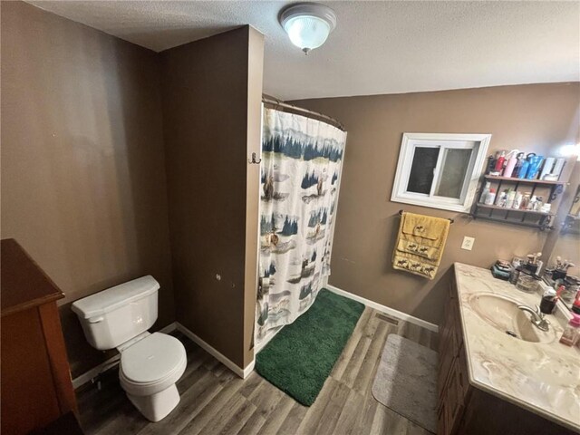 32592 SE 500th Rd, Kincaid, KS 66039 - full bathroom with vanity, wood finished floors, curtained shower, and a textured ceiling