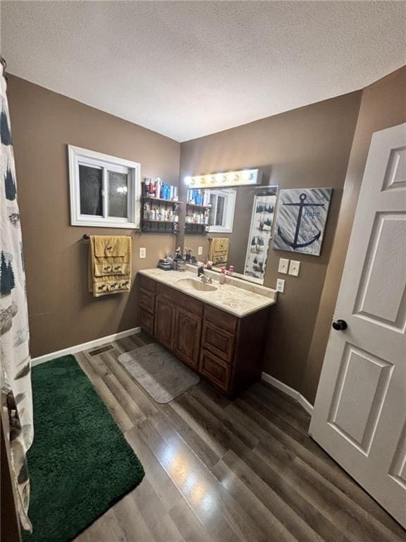 32592 SE 500th Rd, Kincaid, KS 66039 - full bathroom with vanity, a textured ceiling, and wood finished floors