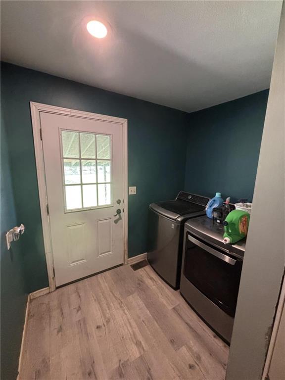 32592 SE 500th Rd, Kincaid, KS 66039 - laundry area with separate washer and dryer and light wood-style floors