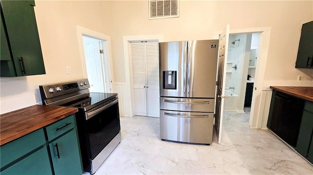 524 S Hill St, Fort Scott, KS 66701 - kitchen with stainless steel appliances, wooden counters, green cabinetry, and light marble finish floors