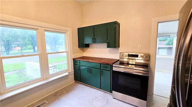 524 S Hill St, Fort Scott, KS 66701 - kitchen featuring stainless steel electric stove, green cabinets, light marble finish floors, and butcher block counters