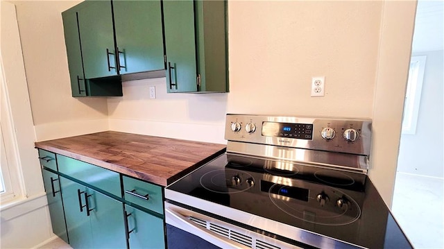 524 S Hill St, Fort Scott, KS 66701 - kitchen featuring electric range, green cabinets, and butcher block counters