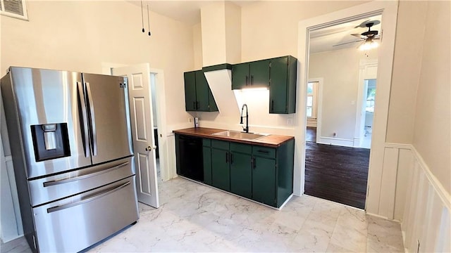 524 S Hill St, Fort Scott, KS 66701 - kitchen with stainless steel fridge, green cabinets, a sink, black dishwasher, and ceiling fan