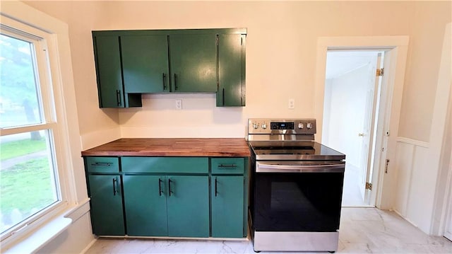524 S Hill St, Fort Scott, KS 66701 - kitchen featuring stainless steel range with electric cooktop, green cabinetry, wooden counters, and light marble finish flooring