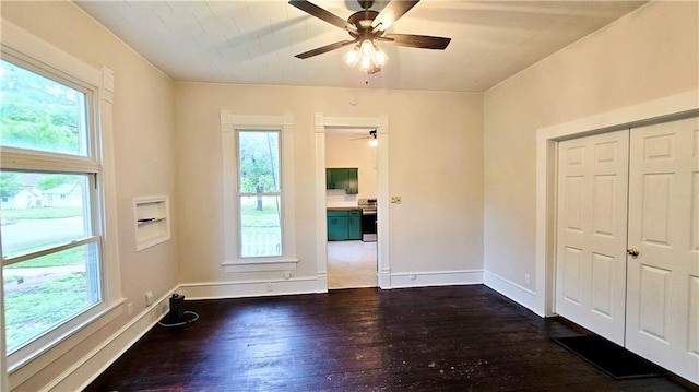 524 S Hill St, Fort Scott, KS 66701 - spare room with ceiling fan, dark wood-style floors, and plenty of natural light