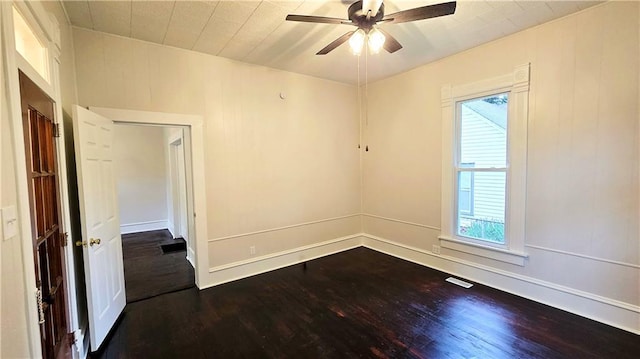 524 S Hill St, Fort Scott, KS 66701 - spare room with dark wood-style floors, plenty of natural light, and a ceiling fan
