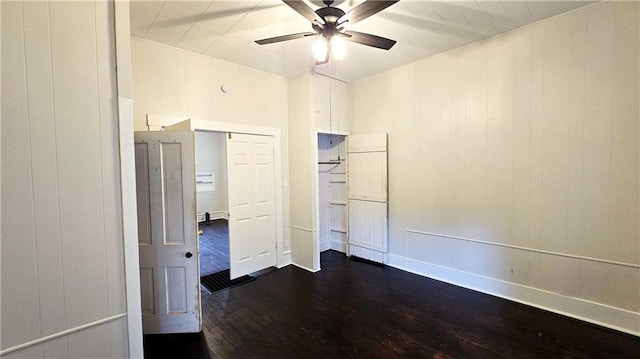 524 S Hill St, Fort Scott, KS 66701 - unfurnished bedroom featuring dark wood-type flooring, baseboards, and a ceiling fan