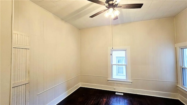 524 S Hill St, Fort Scott, KS 66701 - unfurnished room featuring dark wood finished floors, a ceiling fan, and plenty of natural light