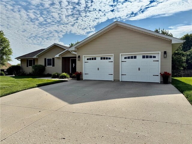226 James Ave, Maryville, MO 64468 - ranch-style home with a front lawn, concrete driveway, and an attached garage