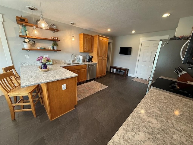 226 James Ave, Maryville, MO 64468 - kitchen with a sink, stainless steel appliances, a peninsula, a textured ceiling, and open shelves