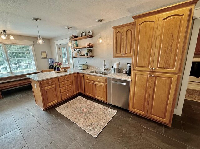 226 James Ave, Maryville, MO 64468 - kitchen with a sink, dishwasher, a peninsula, decorative light fixtures, and a textured ceiling