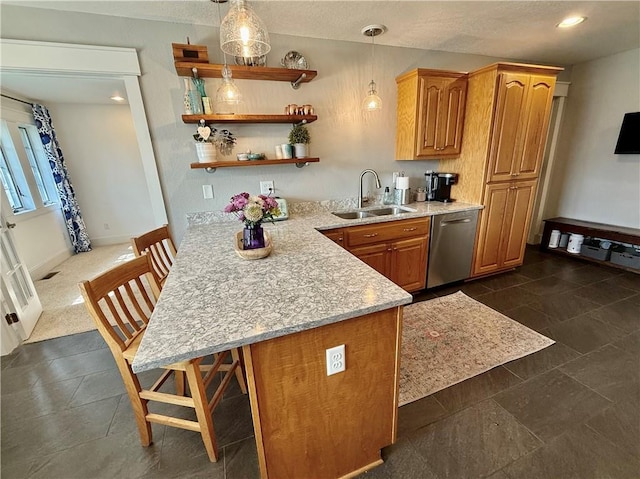 226 James Ave, Maryville, MO 64468 - kitchen with stainless steel dishwasher, a sink, a breakfast bar area, brown cabinets, and a peninsula