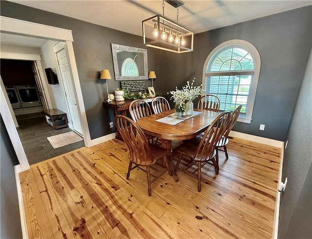 226 James Ave, Maryville, MO 64468 - dining space featuring wood finished floors, baseboards, and a chandelier