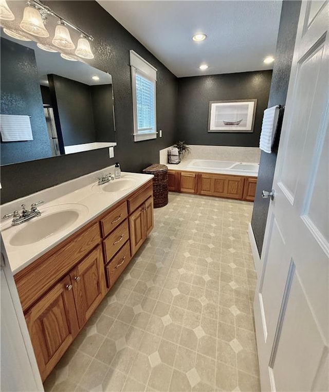 226 James Ave, Maryville, MO 64468 - bathroom featuring double vanity, a garden tub, and a textured wall