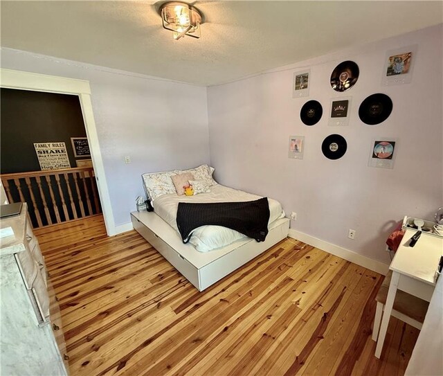 226 James Ave, Maryville, MO 64468 - bedroom with wood finished floors and baseboards