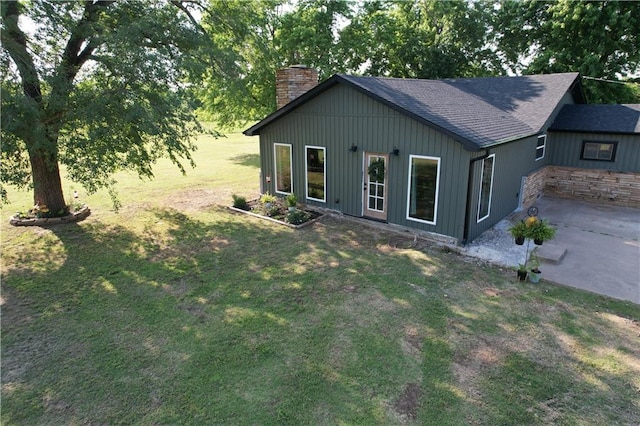 4004 Texaco Rd, Cushing, OK 74023 - view of front facade with a chimney, a patio, a front yard, roof with shingles, and stone siding