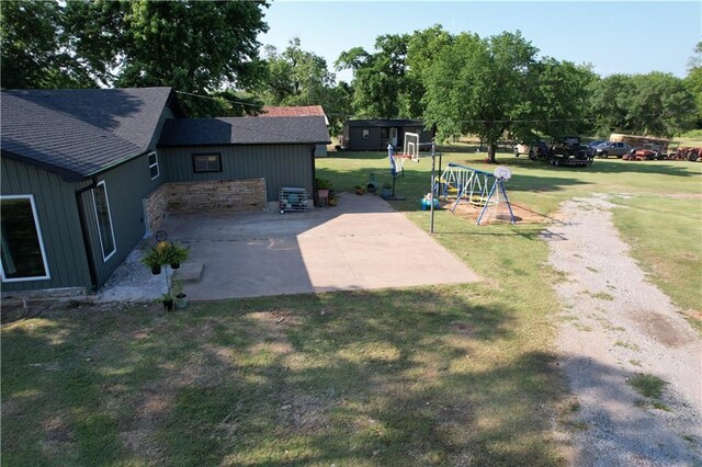 4004 Texaco Rd, Cushing, OK 74023 - view of green lawn with a patio, a playground, and driveway