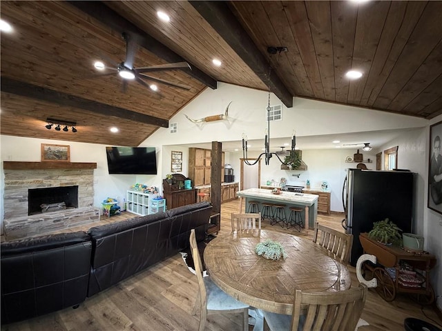 4004 Texaco Rd, Cushing, OK 74023 - dining room with light wood-style flooring, ceiling fan, wooden ceiling, recessed lighting, and a stone fireplace