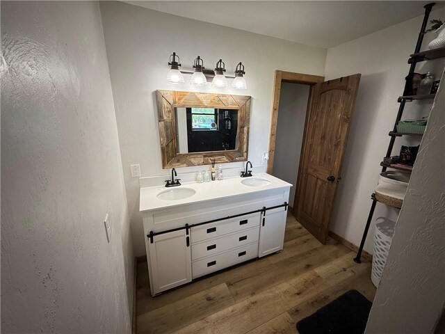 4004 Texaco Rd, Cushing, OK 74023 - full bathroom featuring wood finished floors and double vanity