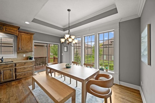 17208 W 198th St, Spring Hill, KS 66083 - dining area with a chandelier, dark wood-type flooring, crown molding, a tray ceiling, and recessed lighting