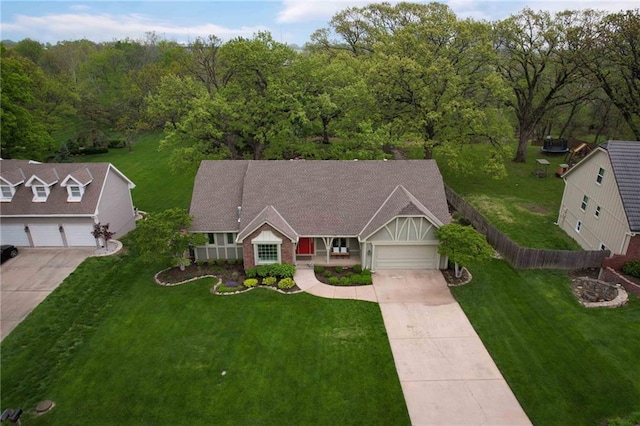 10775 Larsen St, Overland Park, KS 66210 - view of front of home featuring concrete driveway, a garage, and a view of trees