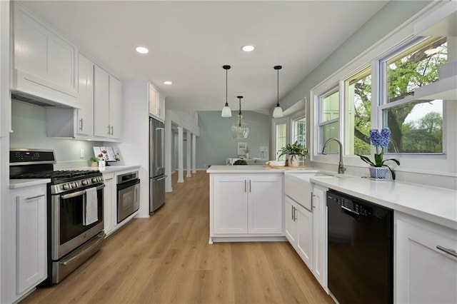 10775 Larsen St, Overland Park, KS 66210 - kitchen with stainless steel appliances, white cabinetry, light countertops, a peninsula, and recessed lighting