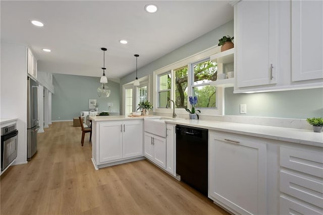 10775 Larsen St, Overland Park, KS 66210 - kitchen with stainless steel appliances, white cabinets, recessed lighting, a peninsula, and light wood-style flooring