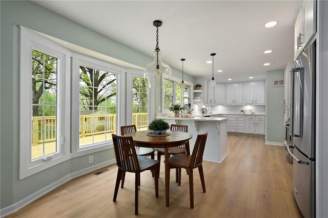 10775 Larsen St, Overland Park, KS 66210 - dining area with plenty of natural light, light wood-style floors, recessed lighting, and baseboards