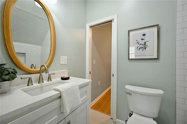 10775 Larsen St, Overland Park, KS 66210 - bathroom with vanity, toilet, and wood finished floors