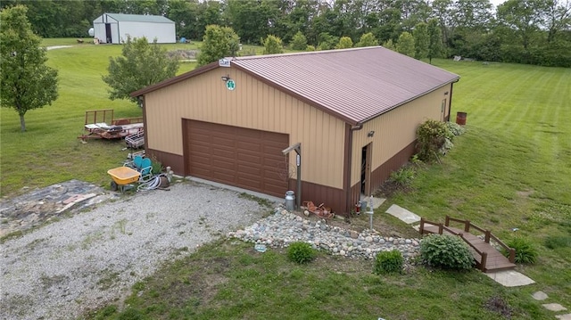5260 SE Fox Run Rd, Lathrop, MO 64465 - detached garage with view of wooded area and gravel driveway