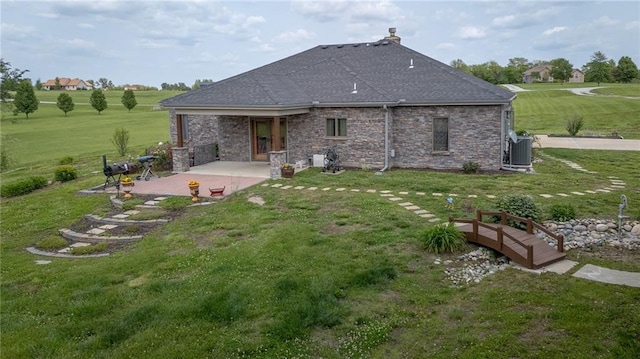 5260 SE Fox Run Rd, Lathrop, MO 64465 - back of property featuring a patio area, a lawn, central air condition unit, and roof with shingles