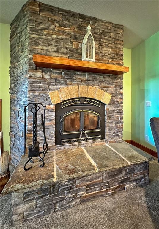 5260 SE Fox Run Rd, Lathrop, MO 64465 - detailed view of a stone fireplace, carpet floors, a textured ceiling, and baseboards