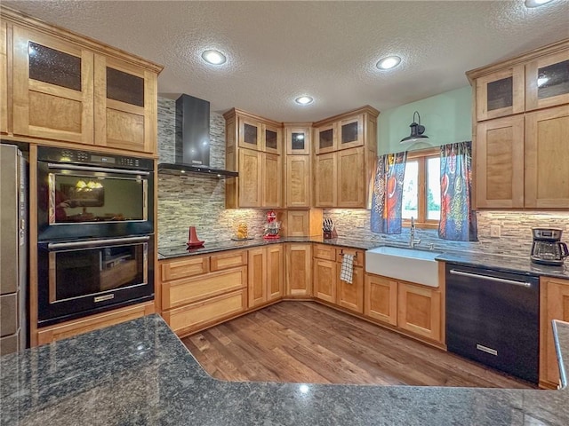 5260 SE Fox Run Rd, Lathrop, MO 64465 - kitchen featuring black appliances, wall chimney range hood, a sink, a textured ceiling, and wood finished floors