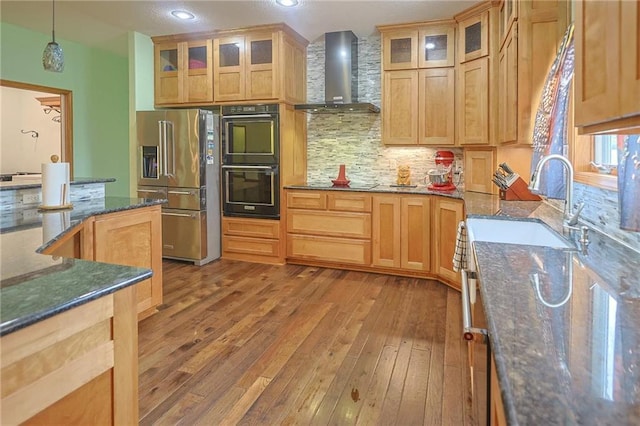 5260 SE Fox Run Rd, Lathrop, MO 64465 - kitchen featuring high quality fridge, wall chimney range hood, light wood-type flooring, decorative backsplash, and dark stone countertops