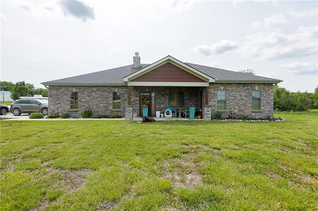 5260 SE Fox Run Rd, Lathrop, MO 64465 - view of front of house featuring a chimney, a front yard, and stone siding