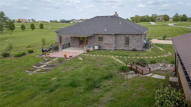 5260 SE Fox Run Rd, Lathrop, MO 64465 - back of property with a patio, a yard, a chimney, and roof with shingles