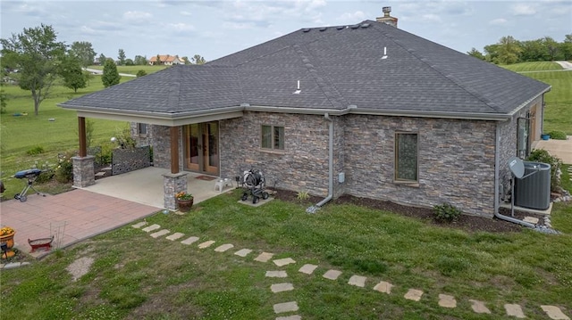 5260 SE Fox Run Rd, Lathrop, MO 64465 - back of property with central air condition unit, a yard, a patio area, and a chimney
