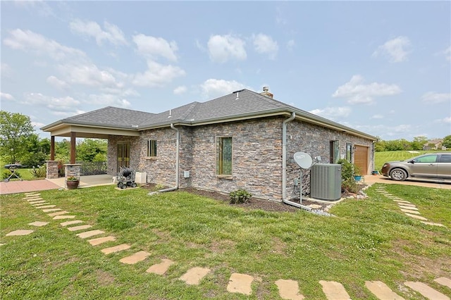 5260 SE Fox Run Rd, Lathrop, MO 64465 - rear view of property featuring cooling unit, a yard, an attached garage, and a chimney