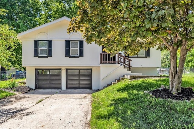 1604 SE Kingsway St, Oak Grove, MO 64075 - view of front of home featuring an attached garage, concrete driveway, and stucco siding