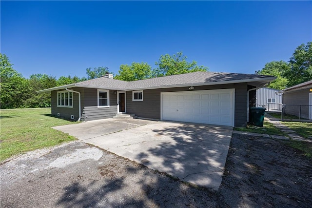 3931 Main St, Parsons, KS 67357 - ranch-style home featuring a garage, a chimney, and concrete driveway