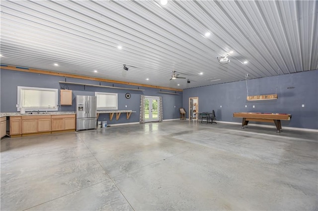 3931 Main St, Parsons, KS 67357 - garage with stainless steel refrigerator with ice dispenser, recessed lighting, a sink, baseboards, and french doors