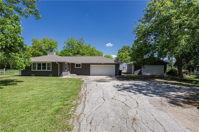 3931 Main St, Parsons, KS 67357 - single story home featuring an attached garage, a chimney, and driveway
