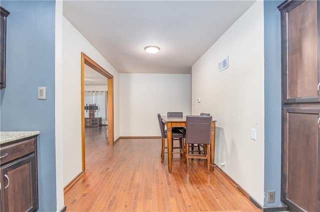 3931 Main St, Parsons, KS 67357 - dining room with light wood-type flooring and baseboards
