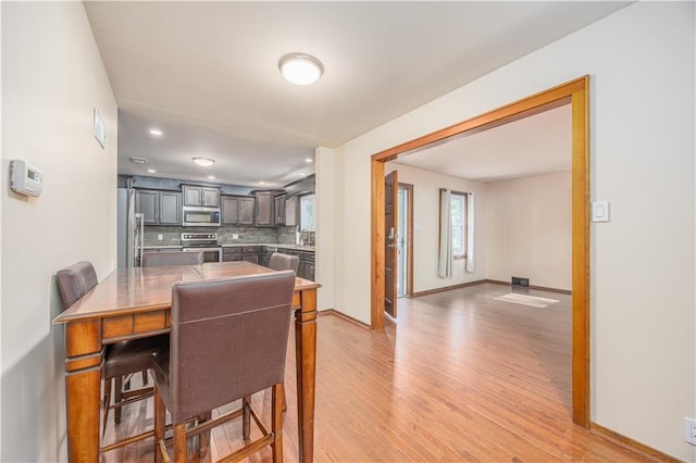 3931 Main St, Parsons, KS 67357 - dining space with light wood finished floors, baseboards, and recessed lighting