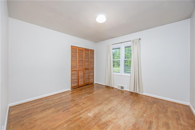 3931 Main St, Parsons, KS 67357 - unfurnished bedroom with light wood-style flooring, baseboards, and a closet