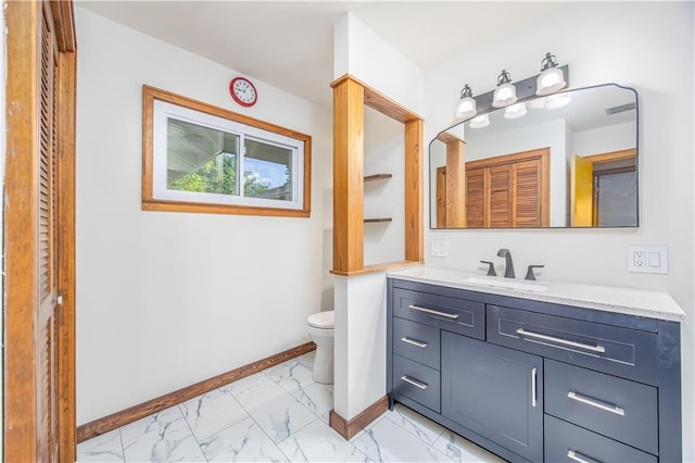 3931 Main St, Parsons, KS 67357 - bathroom with vanity, toilet, baseboards, and marble look tiles