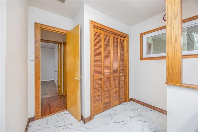3931 Main St, Parsons, KS 67357 - corridor featuring light marble finish flooring and baseboards