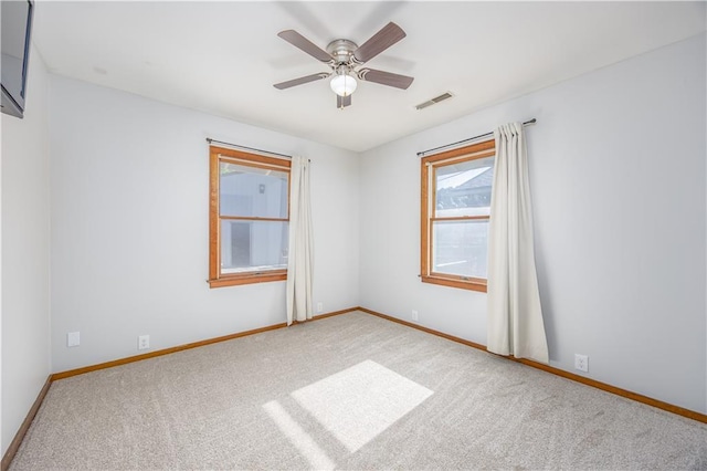 3931 Main St, Parsons, KS 67357 - spare room with light carpet, baseboards, and a ceiling fan