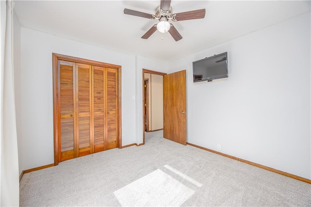 3931 Main St, Parsons, KS 67357 - unfurnished bedroom featuring carpet flooring, a closet, baseboards, and a ceiling fan